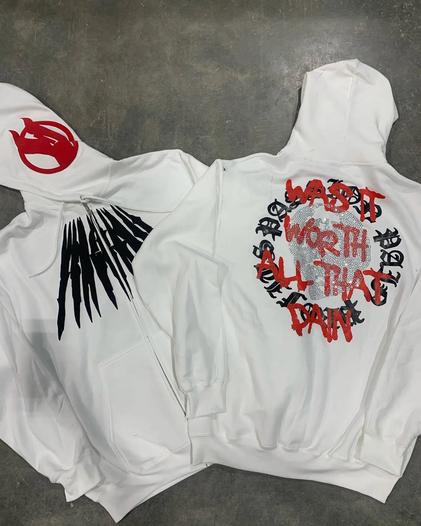 Black loose hooded sweatshirt with white skull print and rhinestone details, cardigan style with long sleeves
