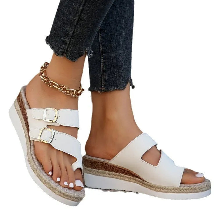 White patent leather woven wedge sandals with a peep toe and finger fit design on a neutral background.