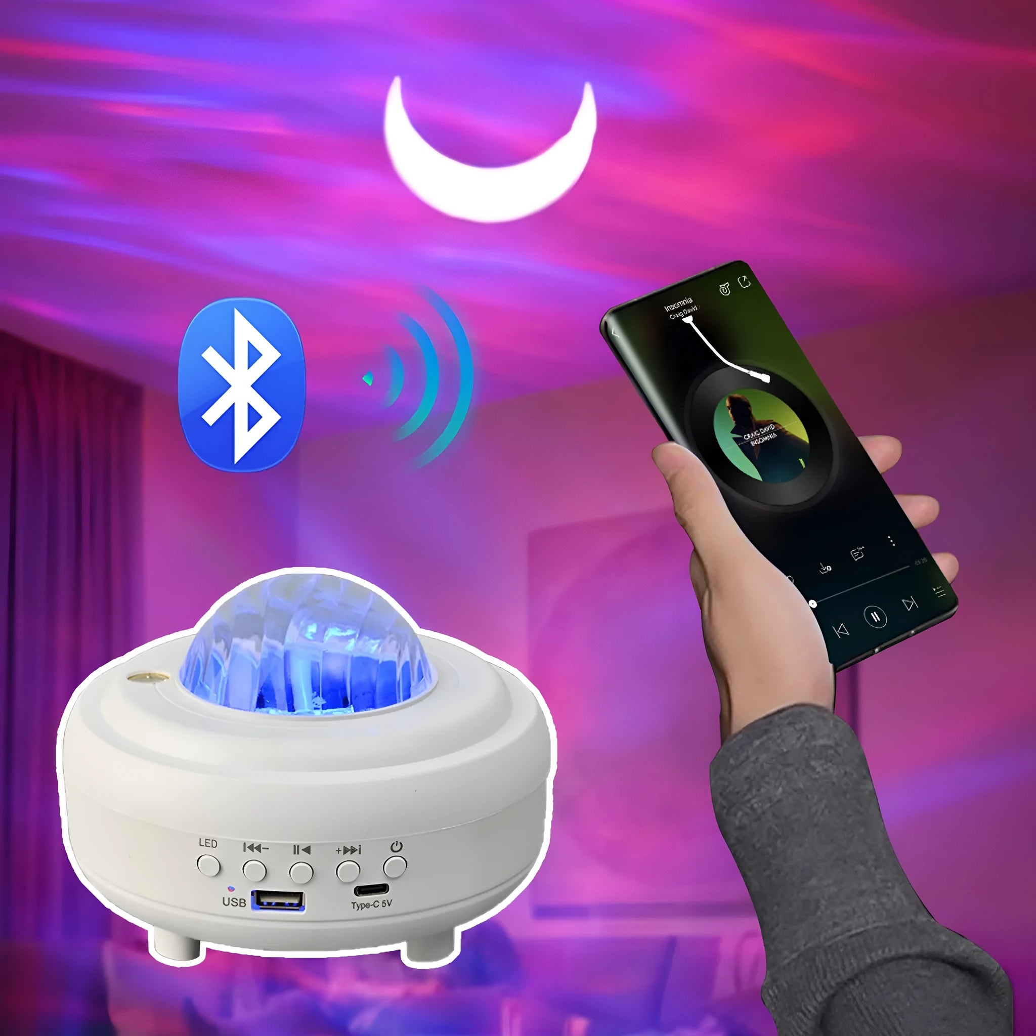 White and black rechargeable galaxy star projector night light with Bluetooth speaker on a table.