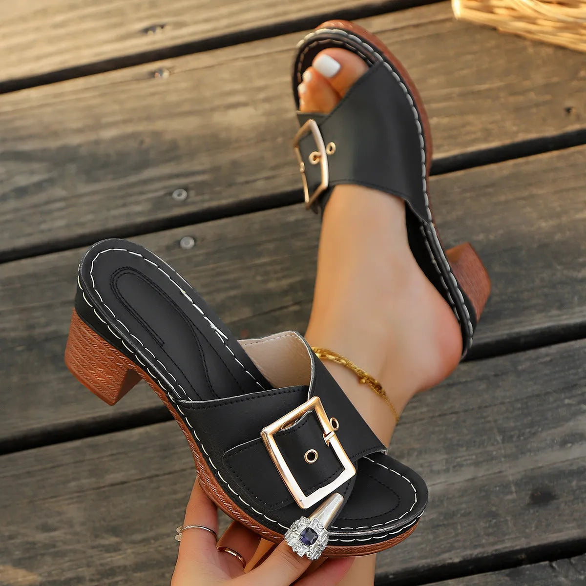 Women's black retro chunky heel slippers with a silver metal buckle closure on a round toe.