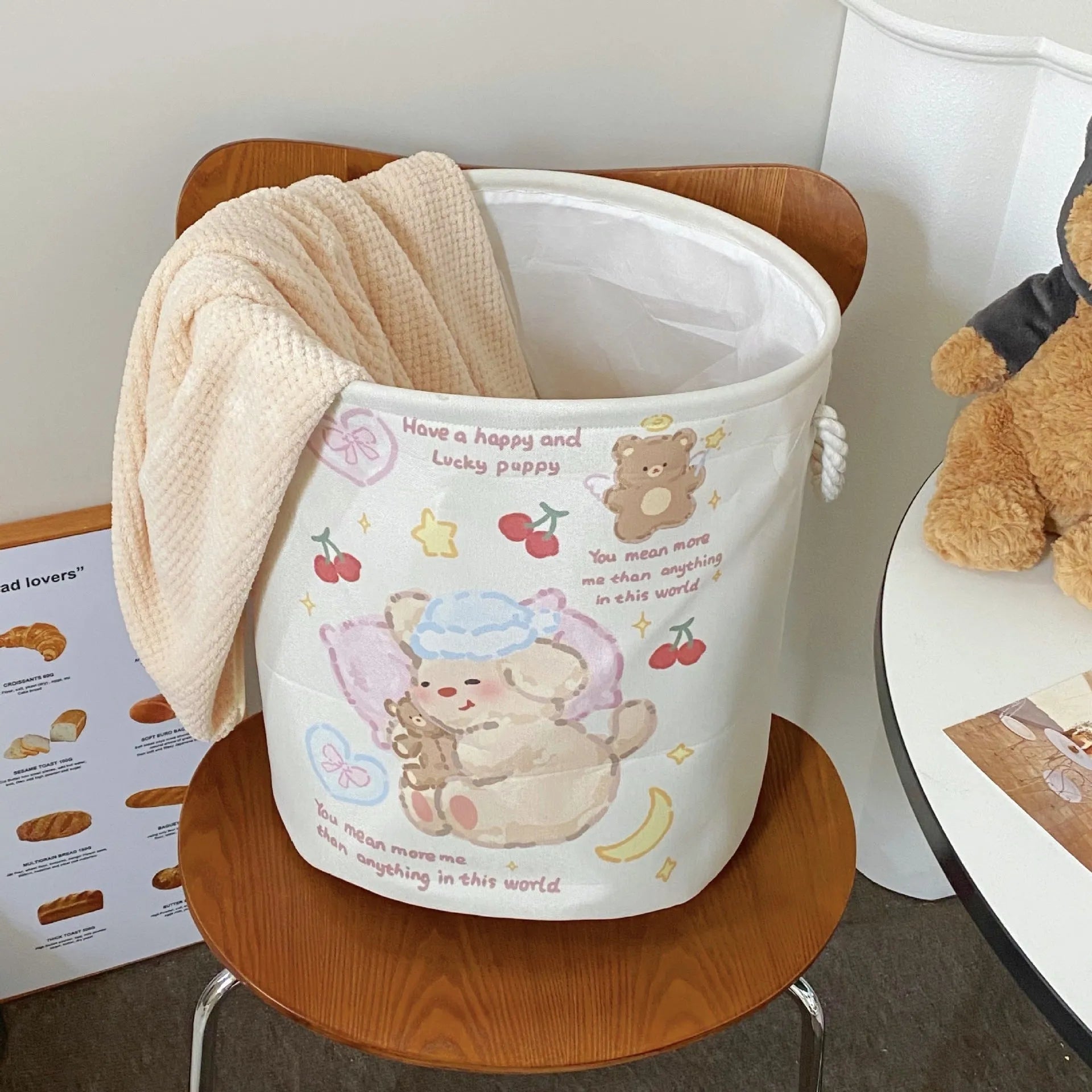 Foldable cotton laundry basket in a colourful design, shown unfolded for use.