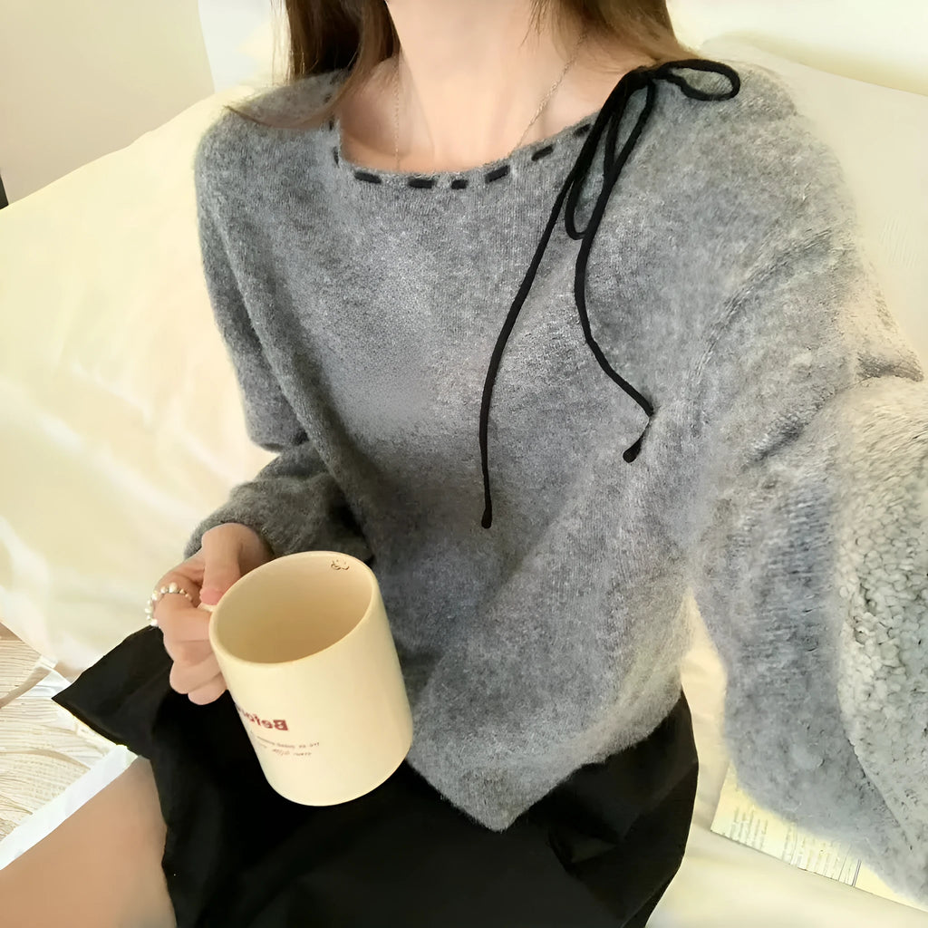 Grey loose-fitting women's knitwear pullover on a hanger