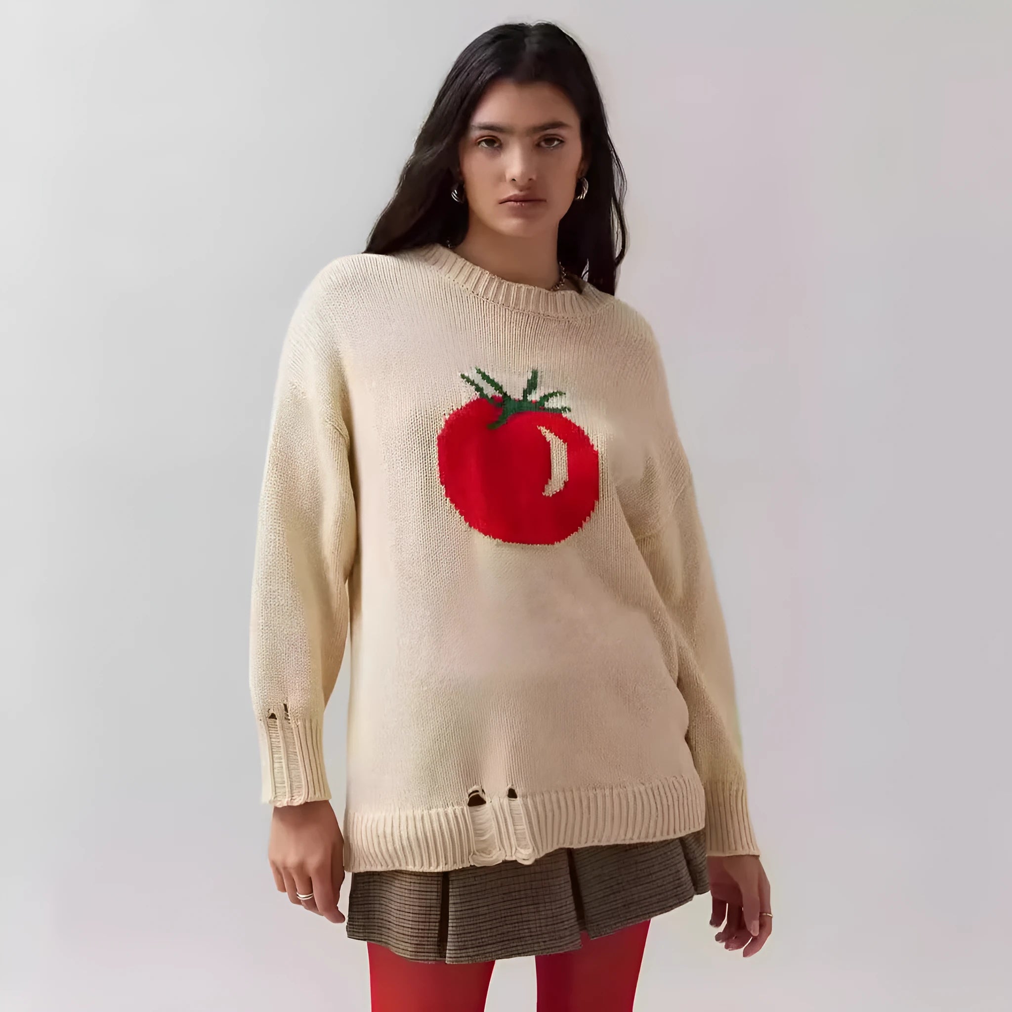 Women's beige loose-fit acrylic Jacquard knit sweater with round neck and long sleeves laid flat.