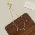 Women's zircon jewellery set showing geometric pendant necklace, matching earrings, and anklet with meteor shower design