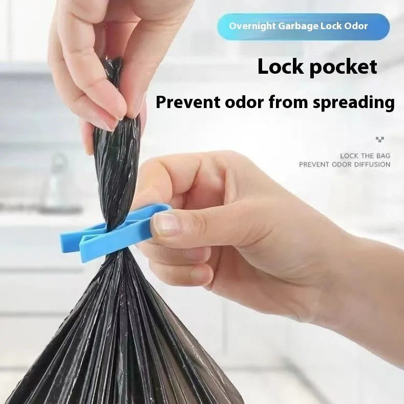 White PP plastic garbage bag fixing clip holding a black bin liner to a trash can rim.