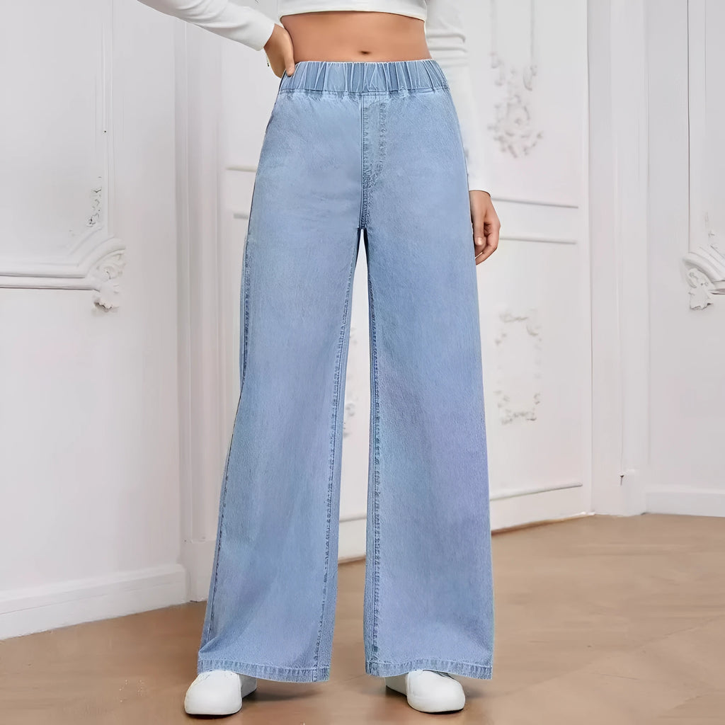Light blue washed wide-leg denim trousers for plus size figures with mid waist and straight leg silhouette