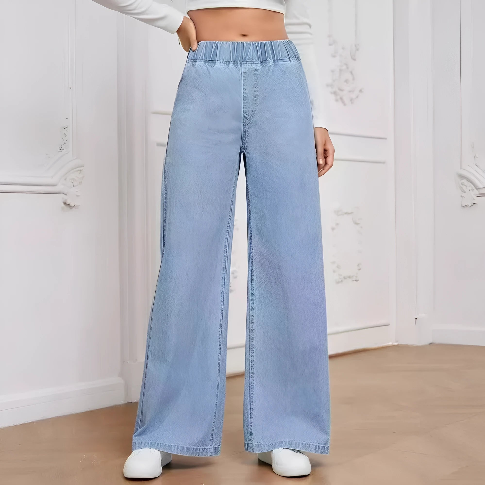 Light blue washed wide-leg denim trousers for plus size figures with mid waist and straight leg silhouette