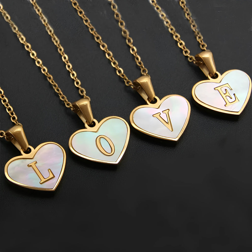 Gold heart necklace with white shell detail and personalised initial letter on adjustable chain