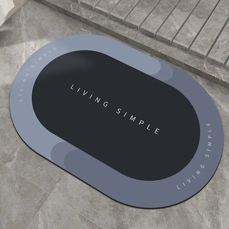 Grey oval super absorbent polyester bath mat with non-slip rubber bottom on tiled floor