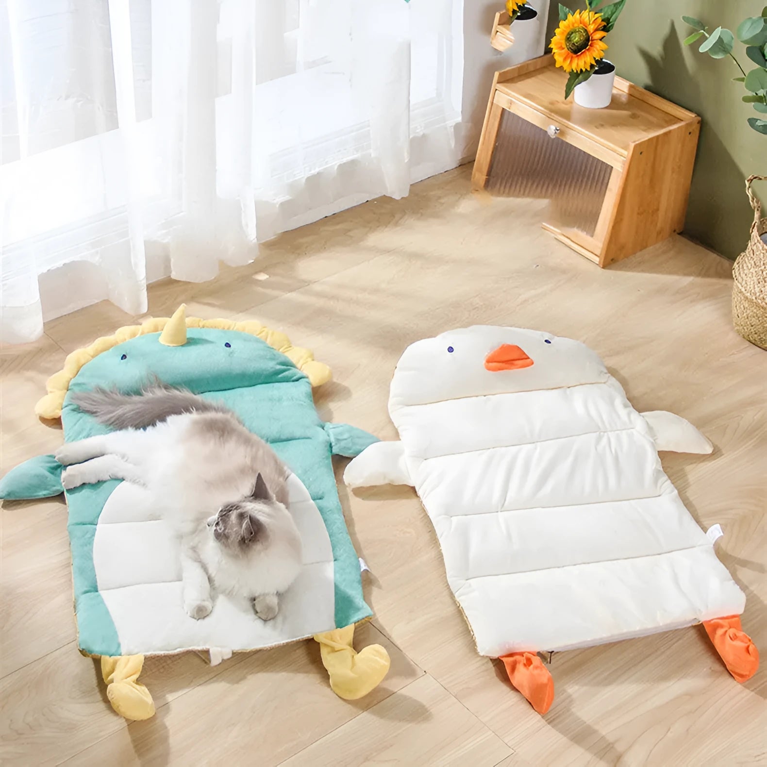 Detachable cool cat bed with ice pad in Green Dinosaur pattern on a indoor surface