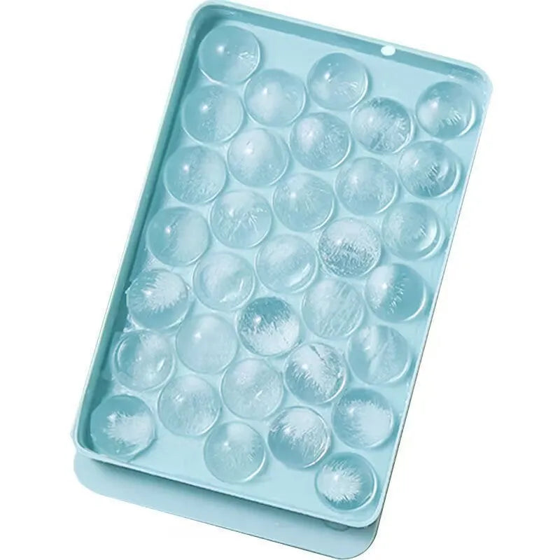 Blue silicone ice cube tray with lid showing 33 round ice moulds