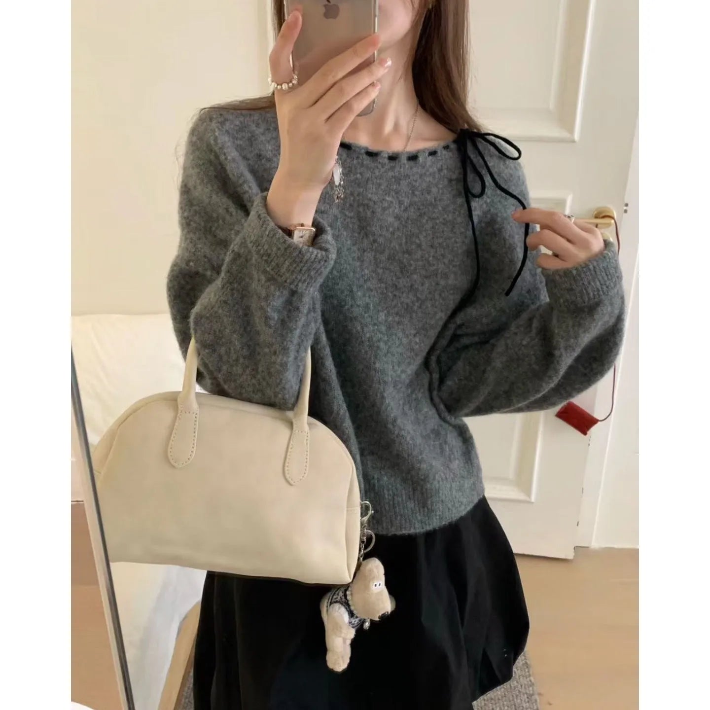 Grey loose-fitting women's knitwear pullover on a hanger