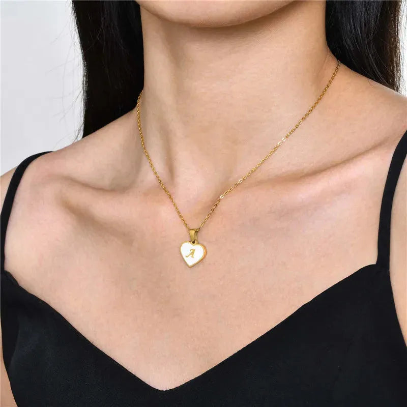 Gold heart necklace with white shell detail and personalised initial letter on adjustable chain