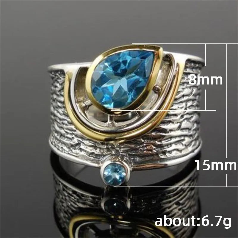 Blue Chinese style alloy ring with inlaid rhinestones in a drop shape on a white background.