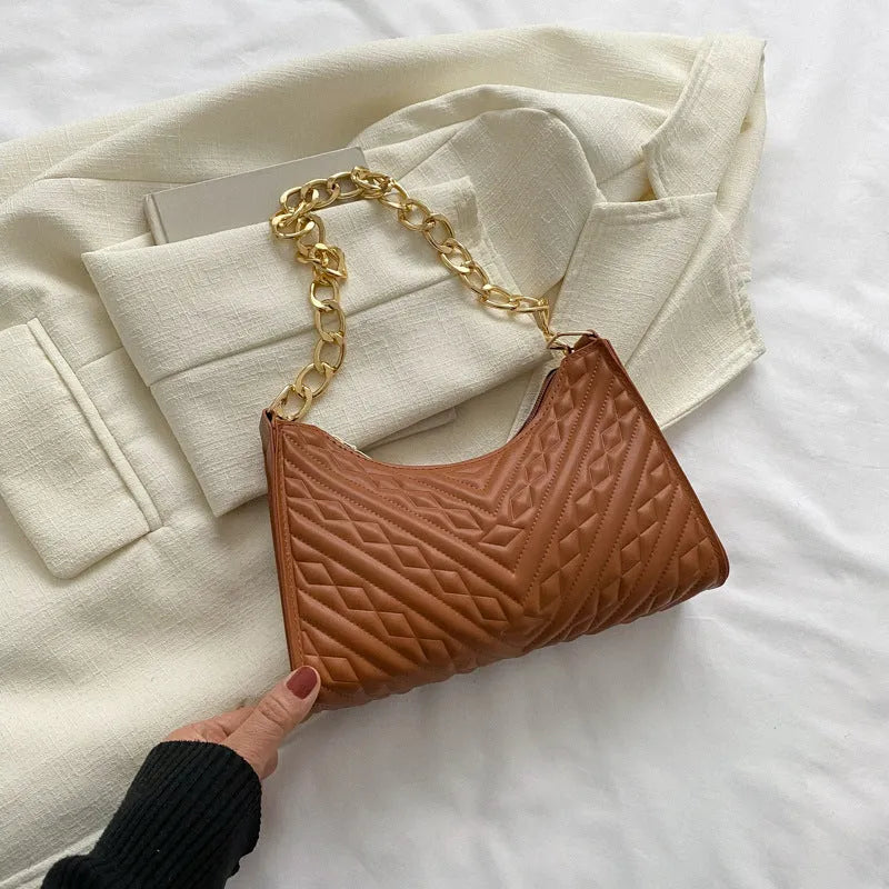 Brown pleated chain shoulder bag showing vertical square shape and adjustable strap