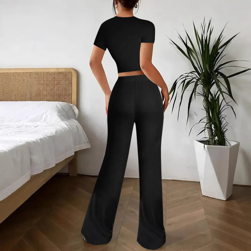 Black high waist trousers and short sleeve t-shirt women's co-ord set on a hanger.