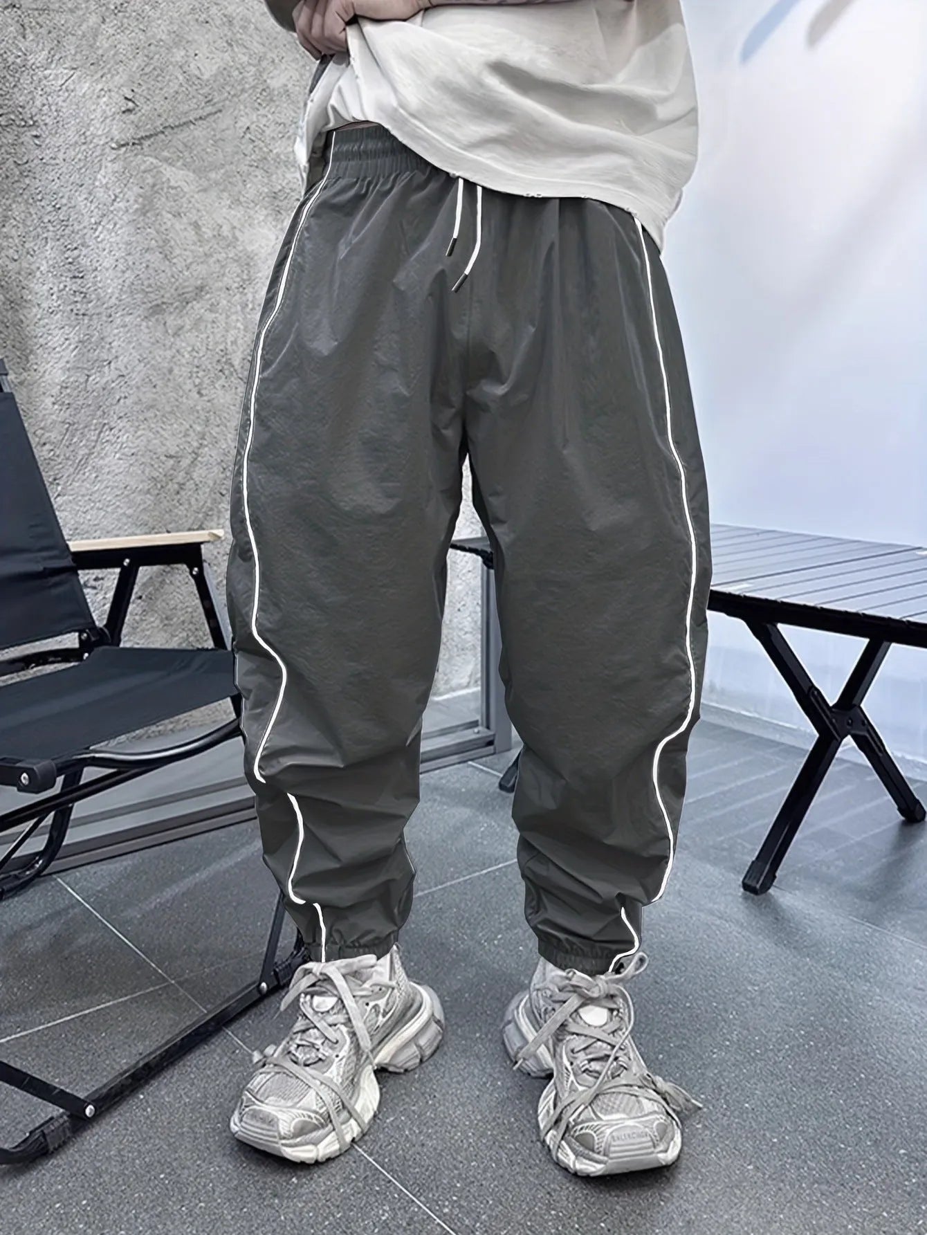 Men's loose blue bamboo fibre cropped sports trousers on a grey background