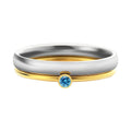 Close-up of a geometric engraved December birthstone ring in gold electroplate on titanium steel.