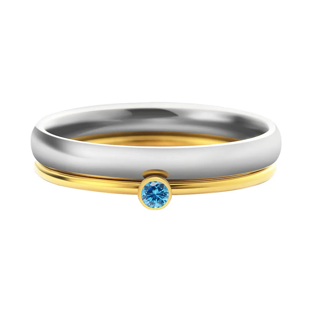 Close-up of a geometric engraved December birthstone ring in gold electroplate on titanium steel.