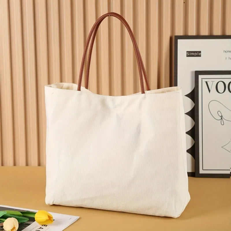 Heavy-duty natural canvas tote bag with long straps and reinforced bottom in beige white colour.