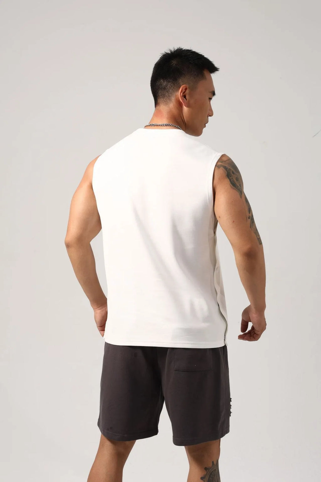 Korean style men's loose cotton fitness vest with hidden hook side openings in black, blue, grey, or white.