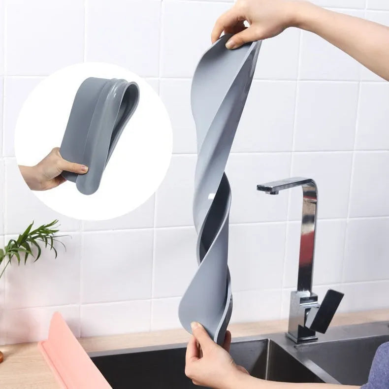 Thick grey blue silicone sink water blocking plate measuring 52mm by 85mm.