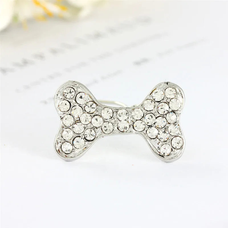 Rhinestone dog bone hair clip in alloy, white colour, on a neutral background