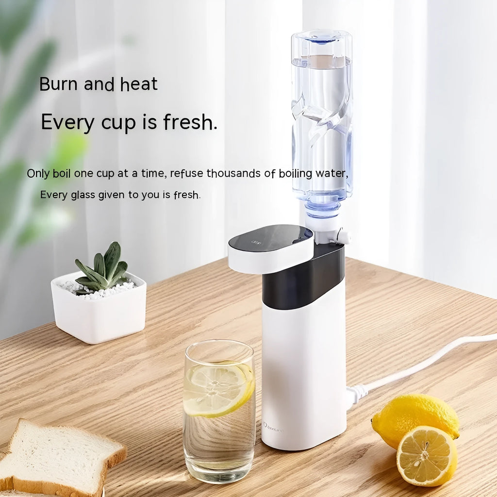 Small black portable instant water dispenser or travel kettle on a desktop.