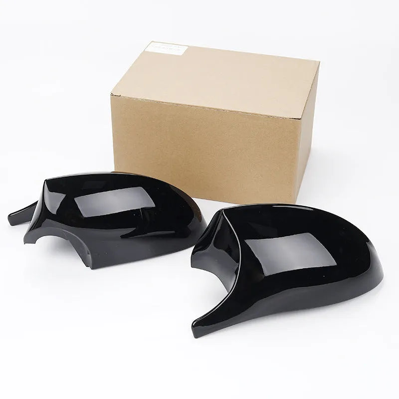 Pair of black ABS plastic rearview mirror shells for BMW 3 Series E90, shown alongside original equipment part numbers.