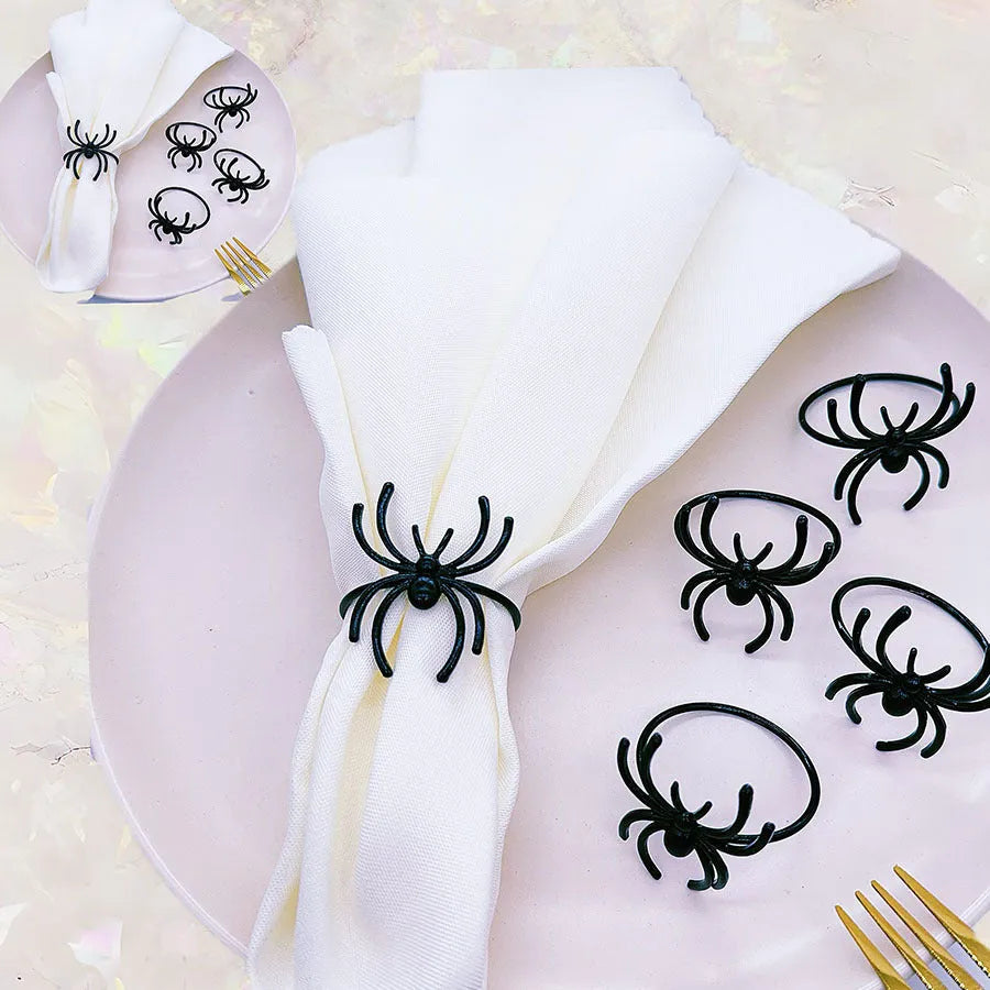 Six black metal spider napkin rings for Halloween table decoration